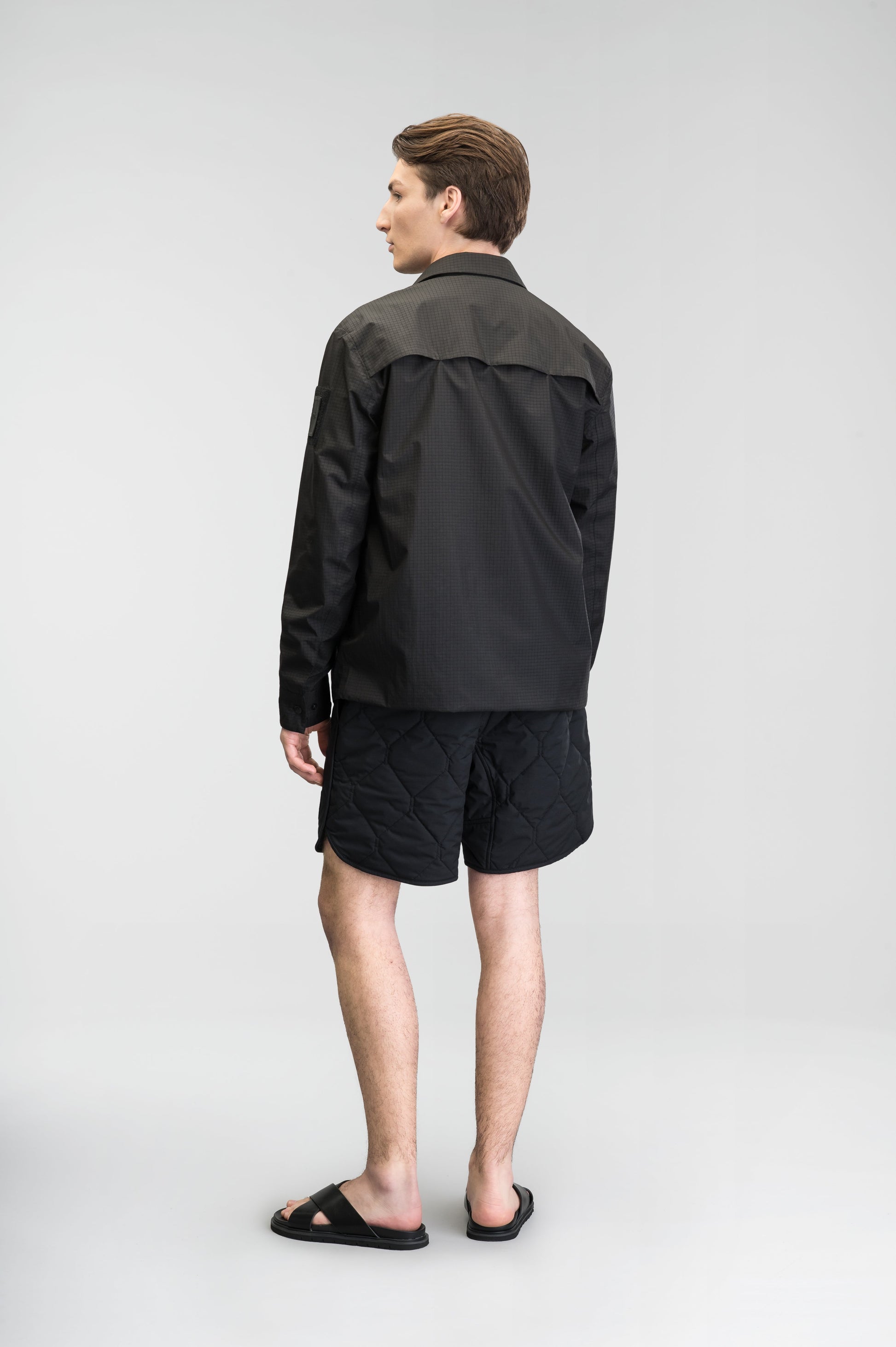 Curt Men's Performance Quilted Shorts at knee length, premium stretch nylon and stretch ripstop fabricaiton, premium 4-way stretch, water resistant Primaloft Gold Insulation Active+, side seam pockets, exteriror back pocket, elasticized waist with drawcords, and notch detailing at side seams, in Black