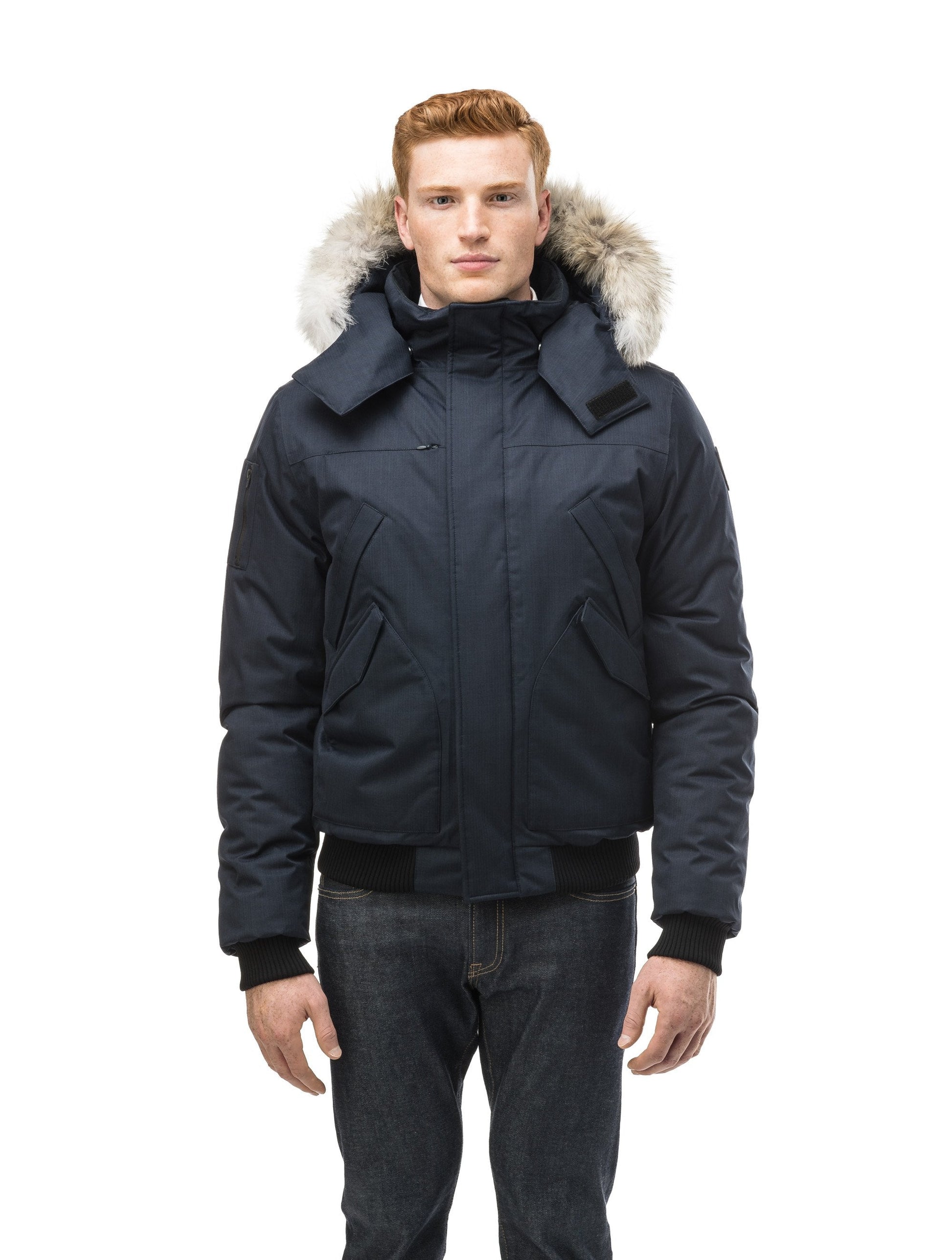 Men's classic down filled bomber jacket with a down filled hood that features a removable coyote fur trim and concealed moldable framing wire in Navy