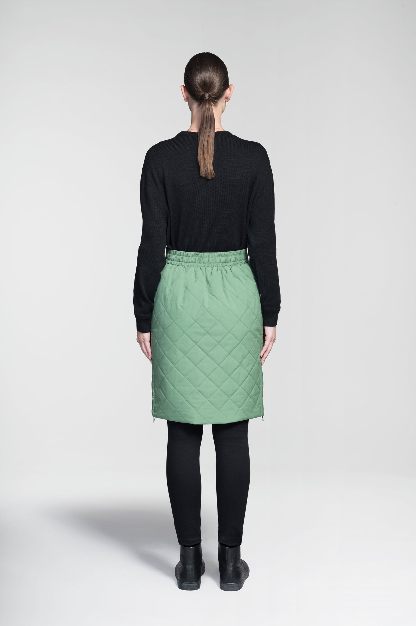 Phora Women's Tailored Skirt in knee length, premium stretch ripstop and contrast cire technical nylon taffeta fabrication, premium 4-way stretch, water resistant Primaloft Gold Insulation Active+, elasticated waistband with grosgrain ribbon drawstrings, two zipper pockets at waist, and zipper closure gusset at side seams, in Comfrey