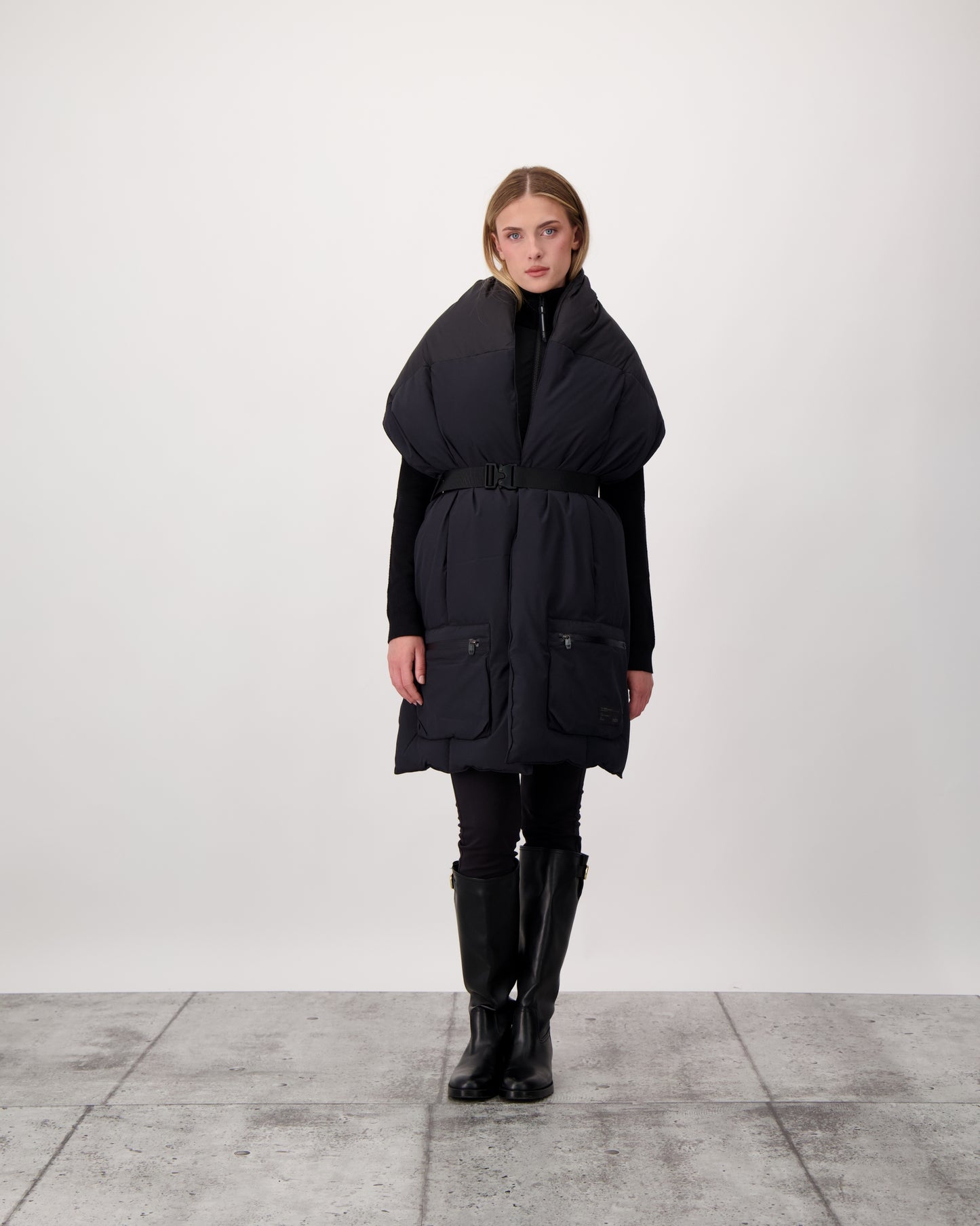 Chroma Unisex Oversized Puffer Scarf in stretch ripstop and taffeta nylon in a quilted pattern, Canadian White Duck Down insulation, cobra buckle belt with webbing strap, and large zipper pocket at scarf end, in Black