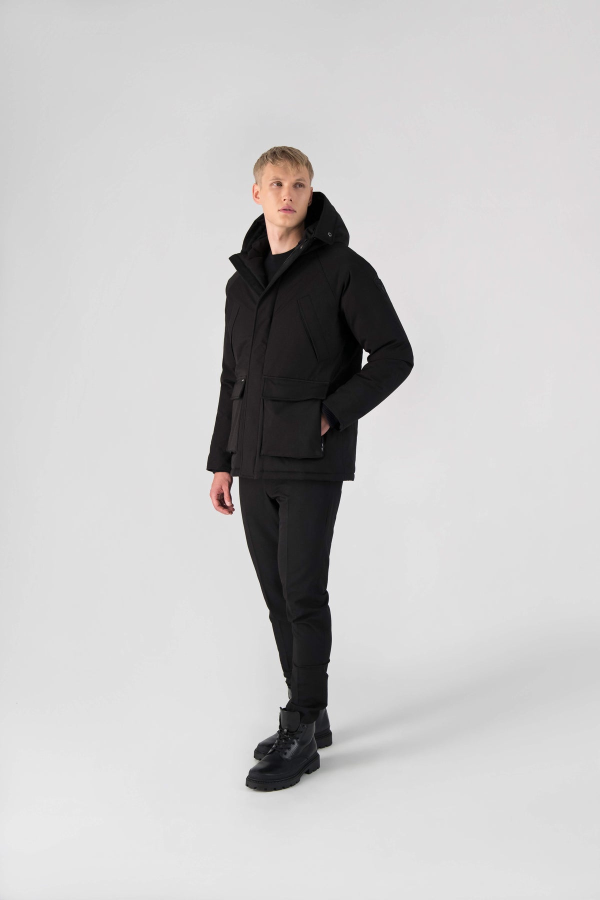 Men's waist length down filled jacket with two front pockets with magnetic closure and a removable fur trim on the hood in Black