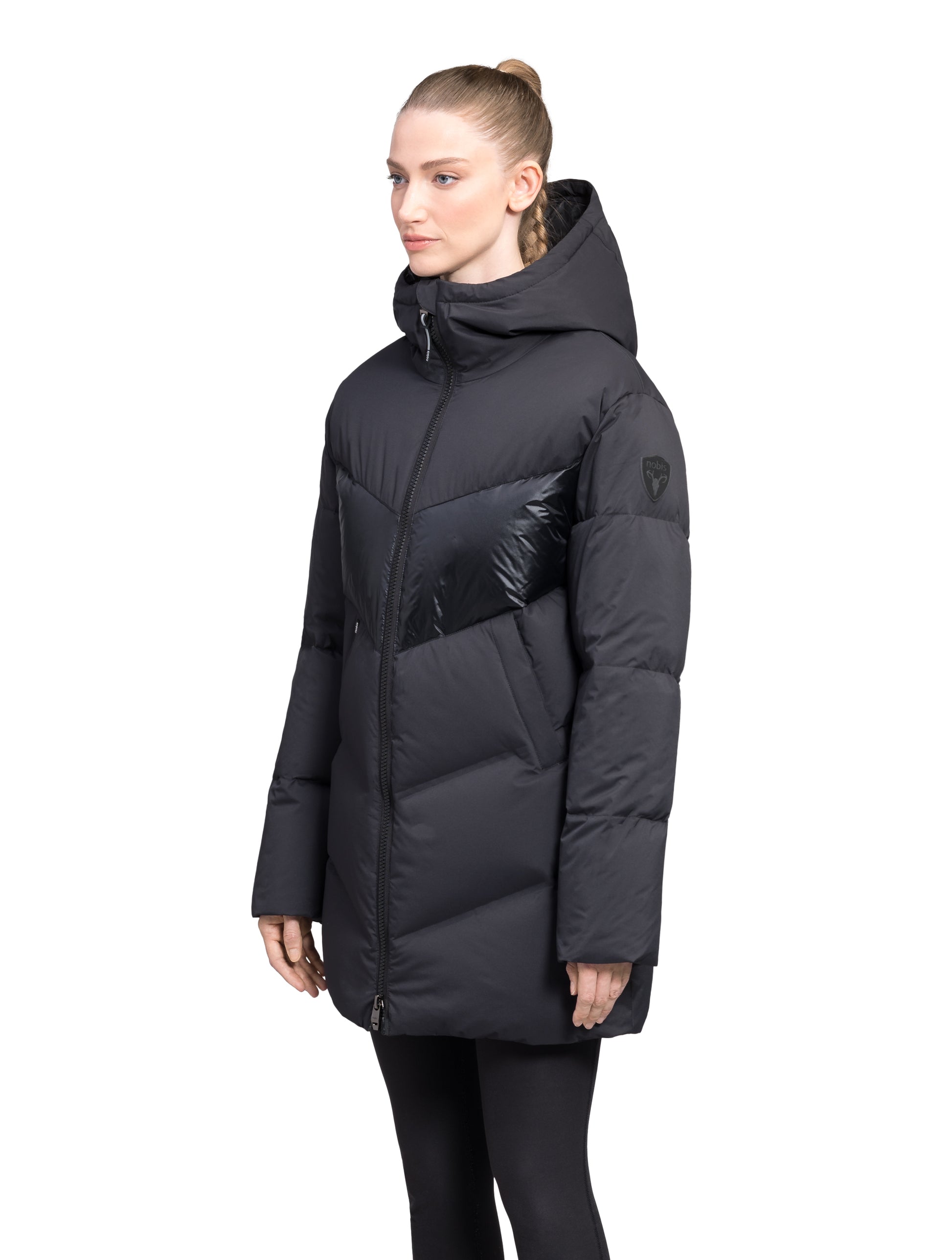 Isla Women's Chevron Quilted Puffer Jacket in thigh length, premium technical nylon taffeta fabrication, Premium Canadian origin White Duck Down insulation, non-removable down-filled hood, two-way centre-front zipper, zipper pockets at waist, contrast cire technical nylon taffeta detailing on chest and back, in Black