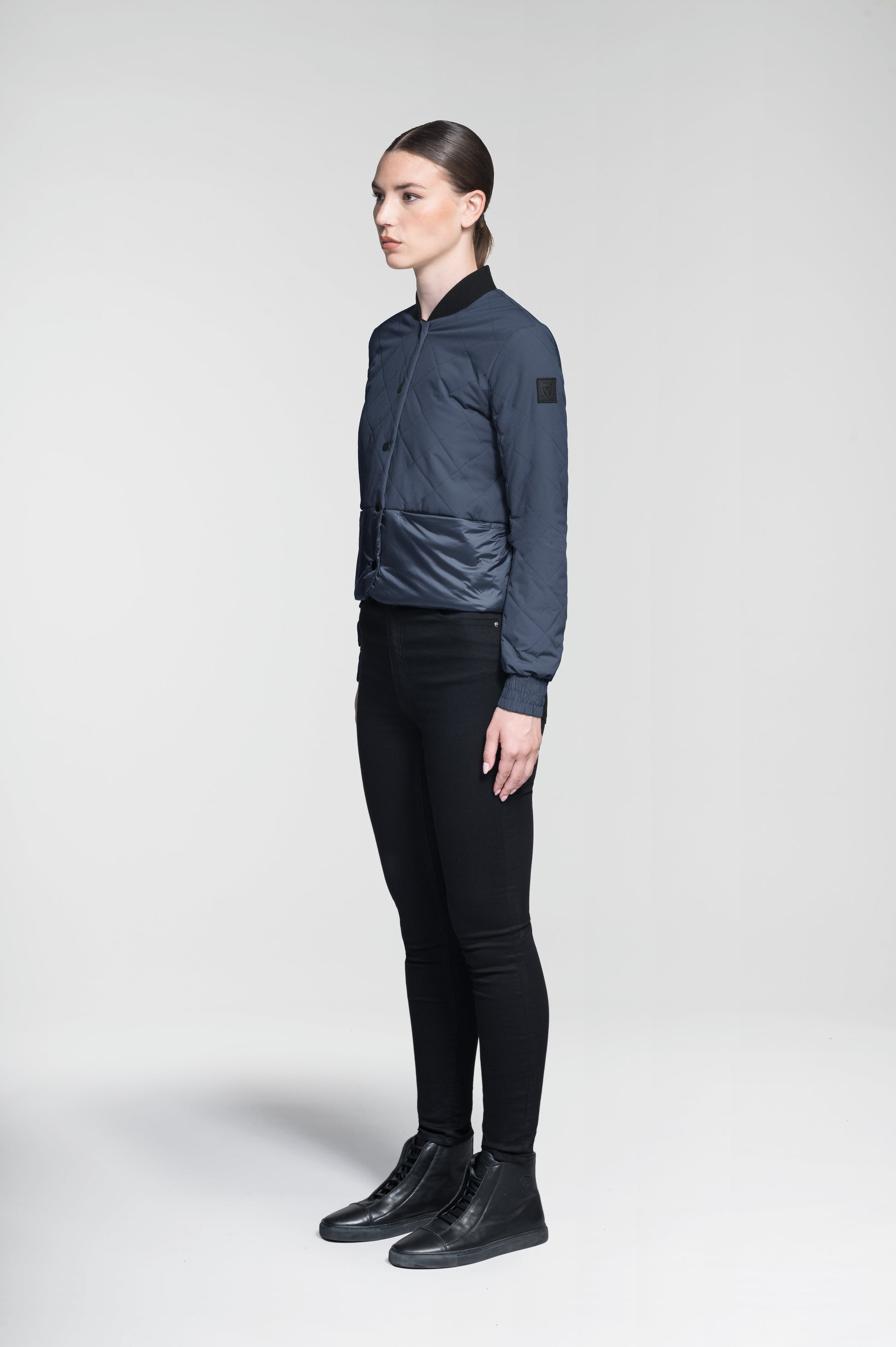 Lexi Women's Reversible Midlayer Jacket in waist length, premium stretch ripstop and contrast cire technical nylon taffeta fabrication, premium 4-way stretch, water resistant Primaloft Gold Insulation Active+, snap button closure at centre front, exterior magnetic closure pockets at sides, elasticized cuff details, and reversible from a quilted or smooth outer shell, in Marine