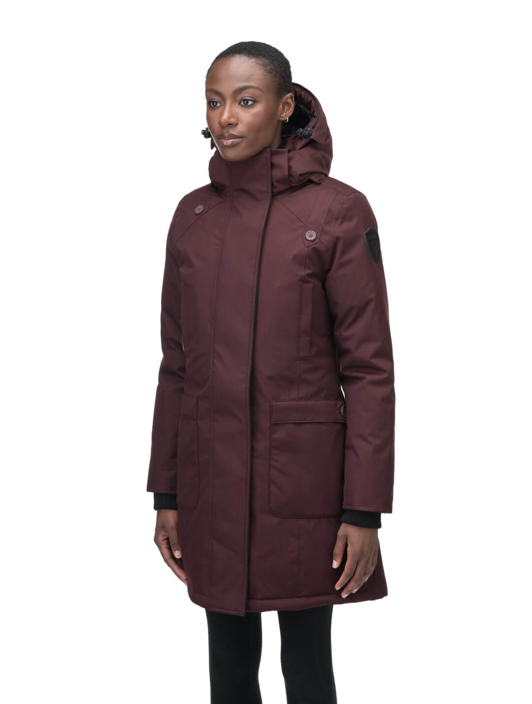 Merideth Furless Ladies Parka in thigh length, Canadian white duck down insulation, removable down-filled hood, centre-front two-way zipper with magnetic wind flap closure, four exterior pockets, and elastic ribbed cuffs, in Merlot
