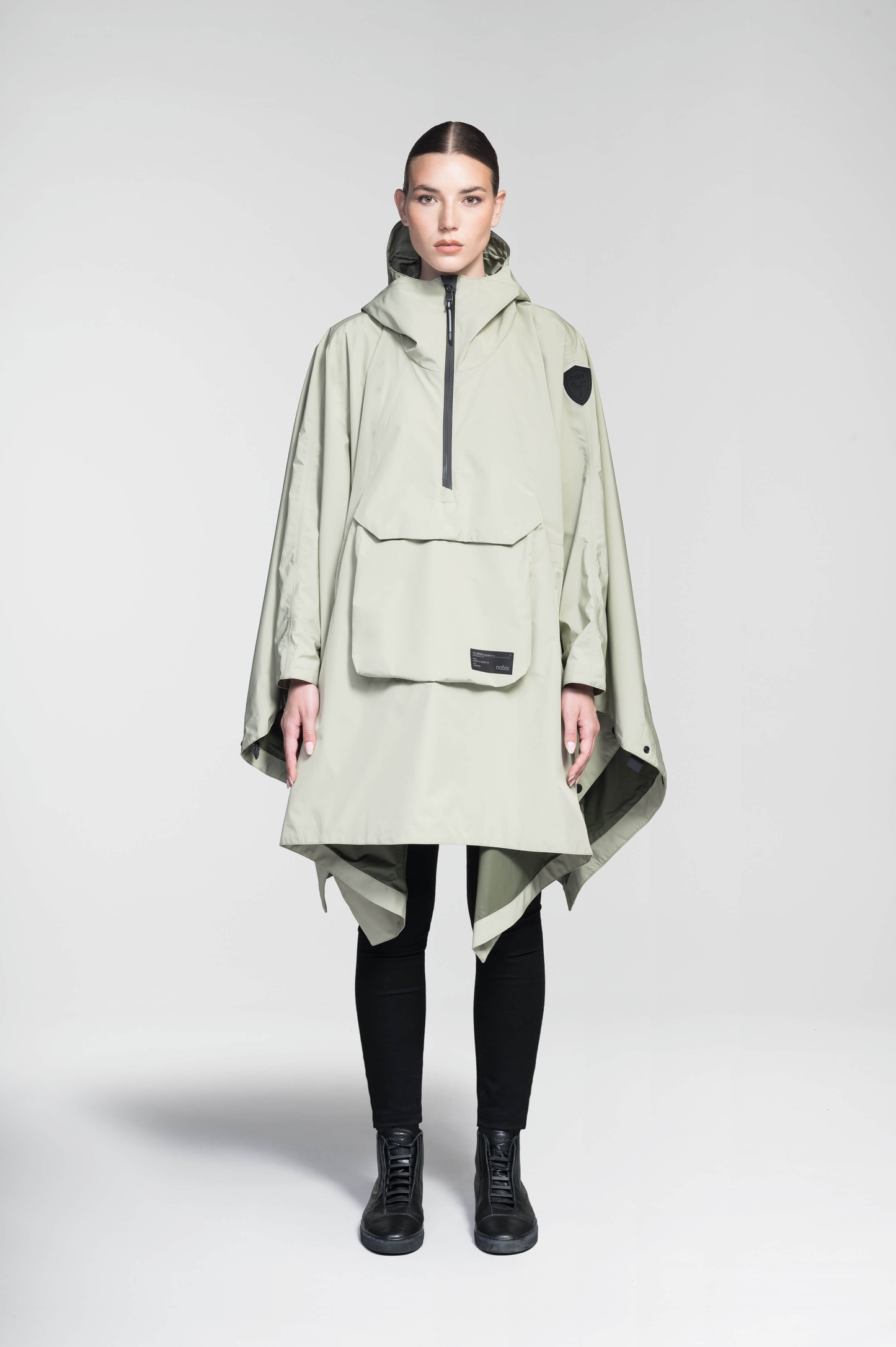 Hydra Unisex Performance Poncho in thigh length, non-removable hood, vertical half-zipper along centre front collar, hidden side-entry waist zipper pockets, adjustable webbing straps and snap closure cuffs, and packable to front kangaroo pocket with flap opening, in Tea