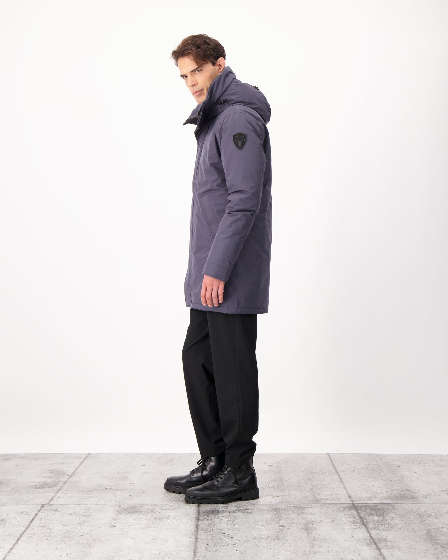 Pierre Men's Jacket in thigh length, Canadian white duck down insulation, non-removable down-filled hood, angled waist pockets, centre-front zipper with wind flap, and elastic ribbed cuffs, in 3L Navy