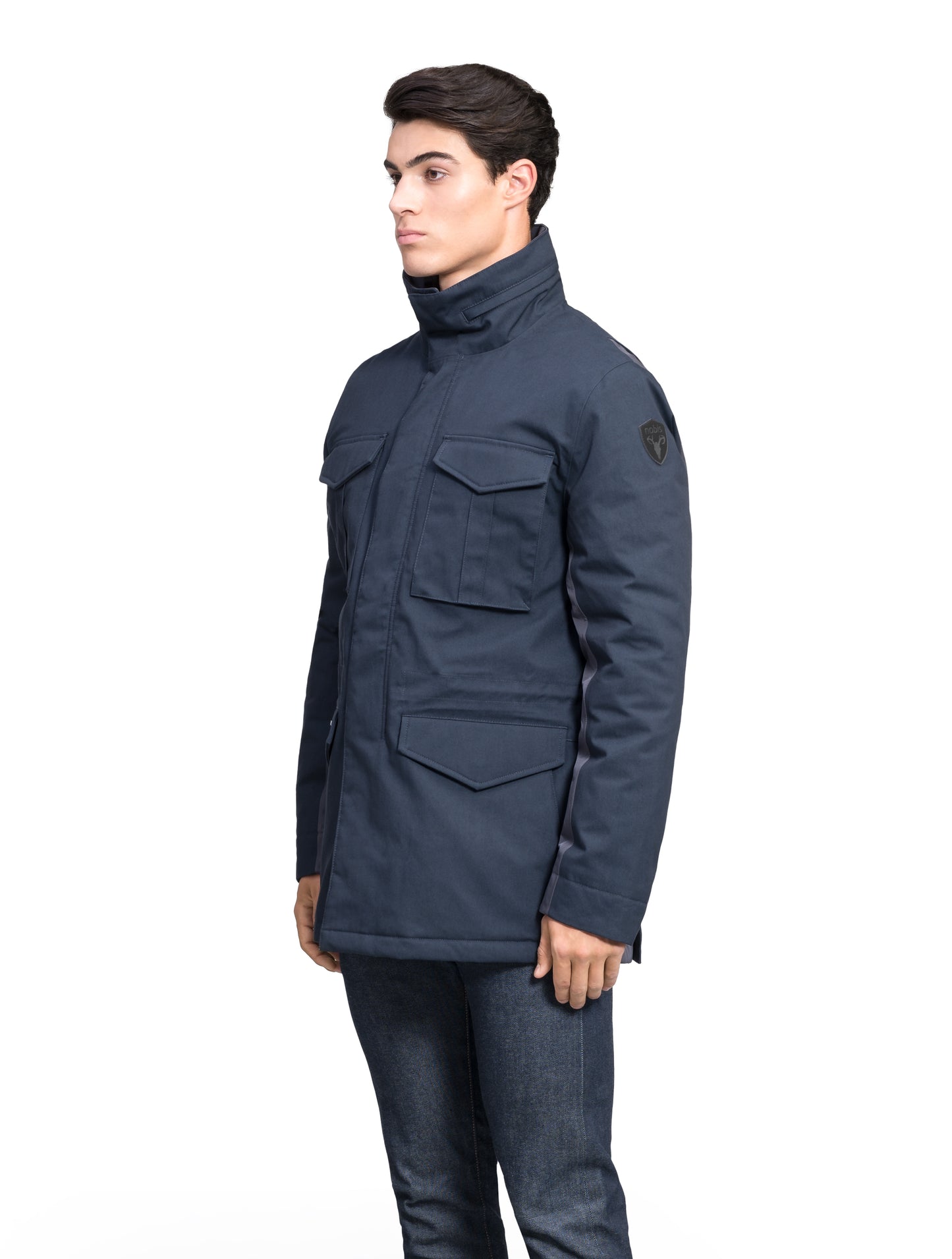 Pelican Men's Tailored Field Jacket in hip length, premium cotton blend and 3-ply micro denier fabrication, Premium Canadian origin White Duck Down insulation, tuck away, waterproof hood in premium cire technical nylon taffeta, two-way centre-front zipper with magnetic wind flap, pit zipper vents, magnetic closure chest and waist flap pockets, hidden adjustable waist drawcord, and action back detailing, in Navy