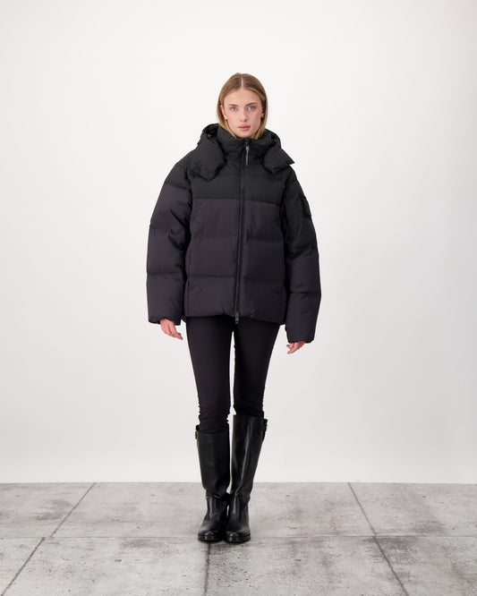 Una Ladies Performance Puffer in hip length, Technical Taffeta and Durable Stretch Ripstop fabrication, Premium Canadian White Duck Down insulation, removable down filled hood, centre front two-way zipper, and side-entry pockets at waist, in Black