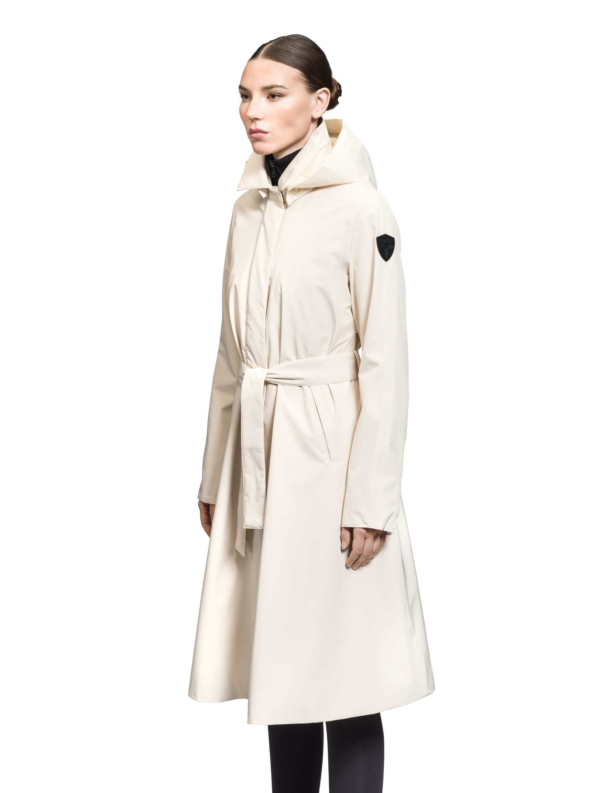 Ivy Ladies Tailored Trench Coat in knee length, 3-Ply Micro Denier fabrication, retractable non-removable hood, front wind flap with snap button closure, removable belt, and adjustable snap cuffs, in Wheat